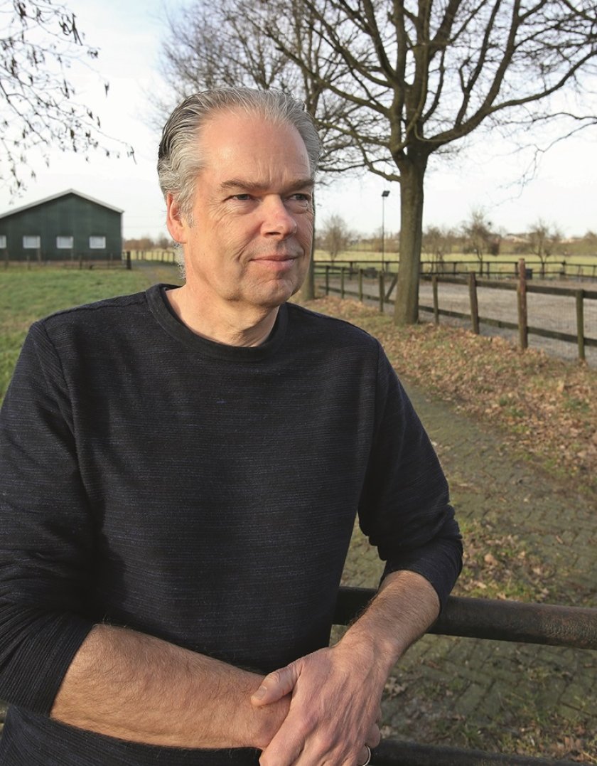 Marko Ruis standing in front of a farm