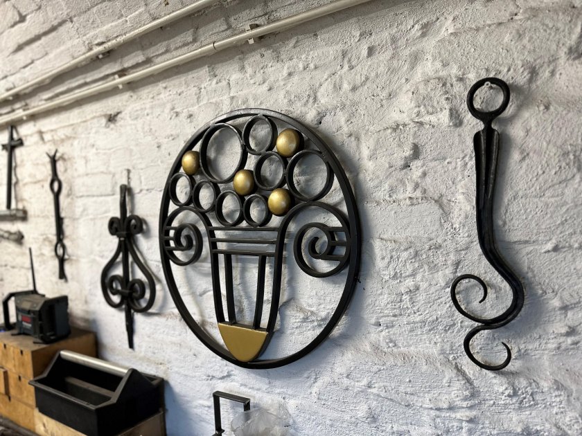 Forged ornamental objects in his forge